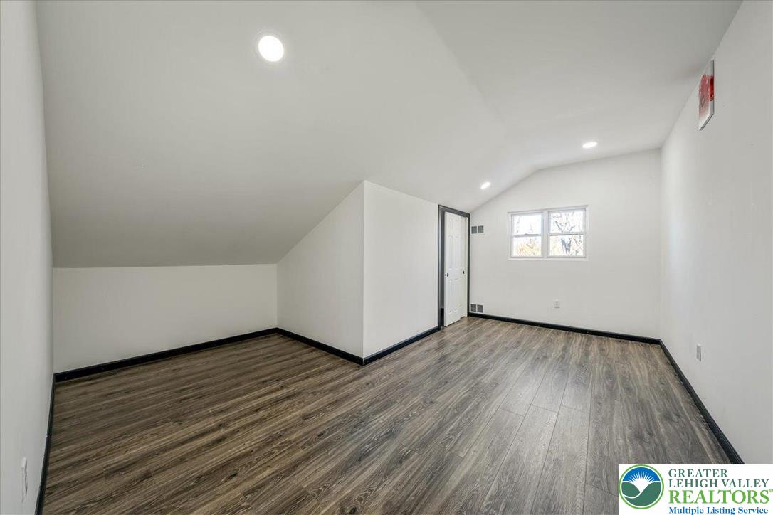 3260 Bluebird Drive Bushkill, PA 18324 - Photo 19 of 28 a view of an empty room with wooden floor and windows