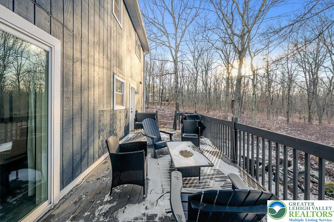 3260 Bluebird Drive Bushkill, PA 18324 - Photo 23 of 28 a roof deck with table and chairs and wooden floor