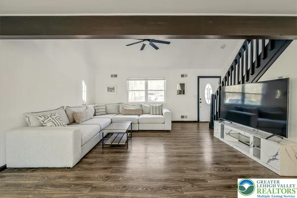 a living room with furniture and a flat screen tv