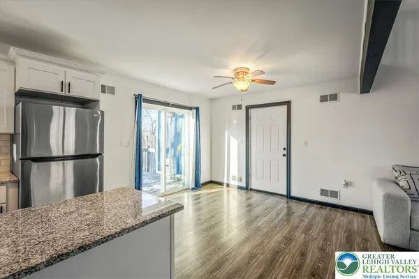 a view of a kitchen with wooden floor and a kitchen space