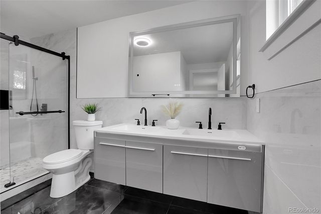 a view of bathroom with a sink toilet and shower