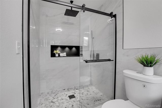 a bathroom with a shower and a toilet