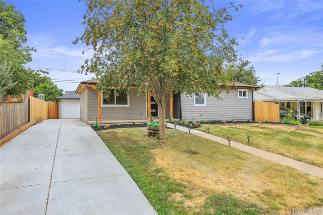 a view of a house with a yard and tree s