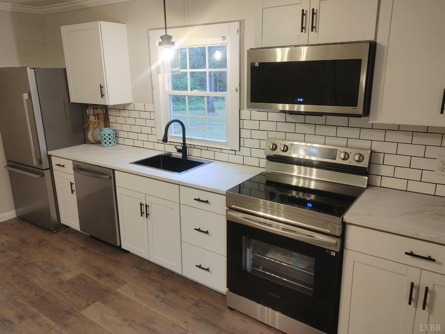 7143 Abilene Road Farmville, VA 23901 - Photo 13 of 38 a kitchen with cabinets stainless steel appliances and a sink