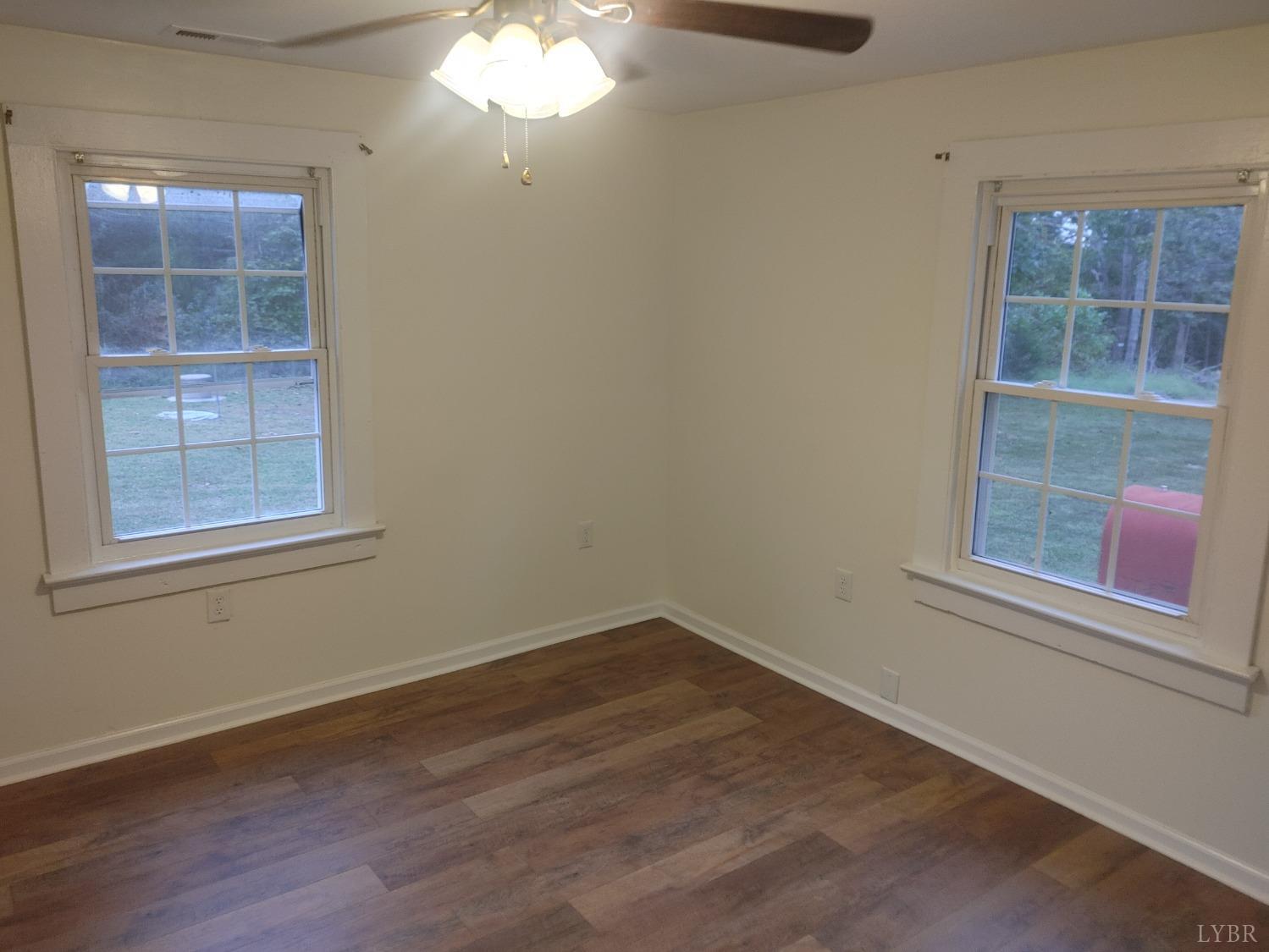 7143 Abilene Road Farmville, VA 23901 - Photo 16 of 38 an empty room with wooden floor and windows