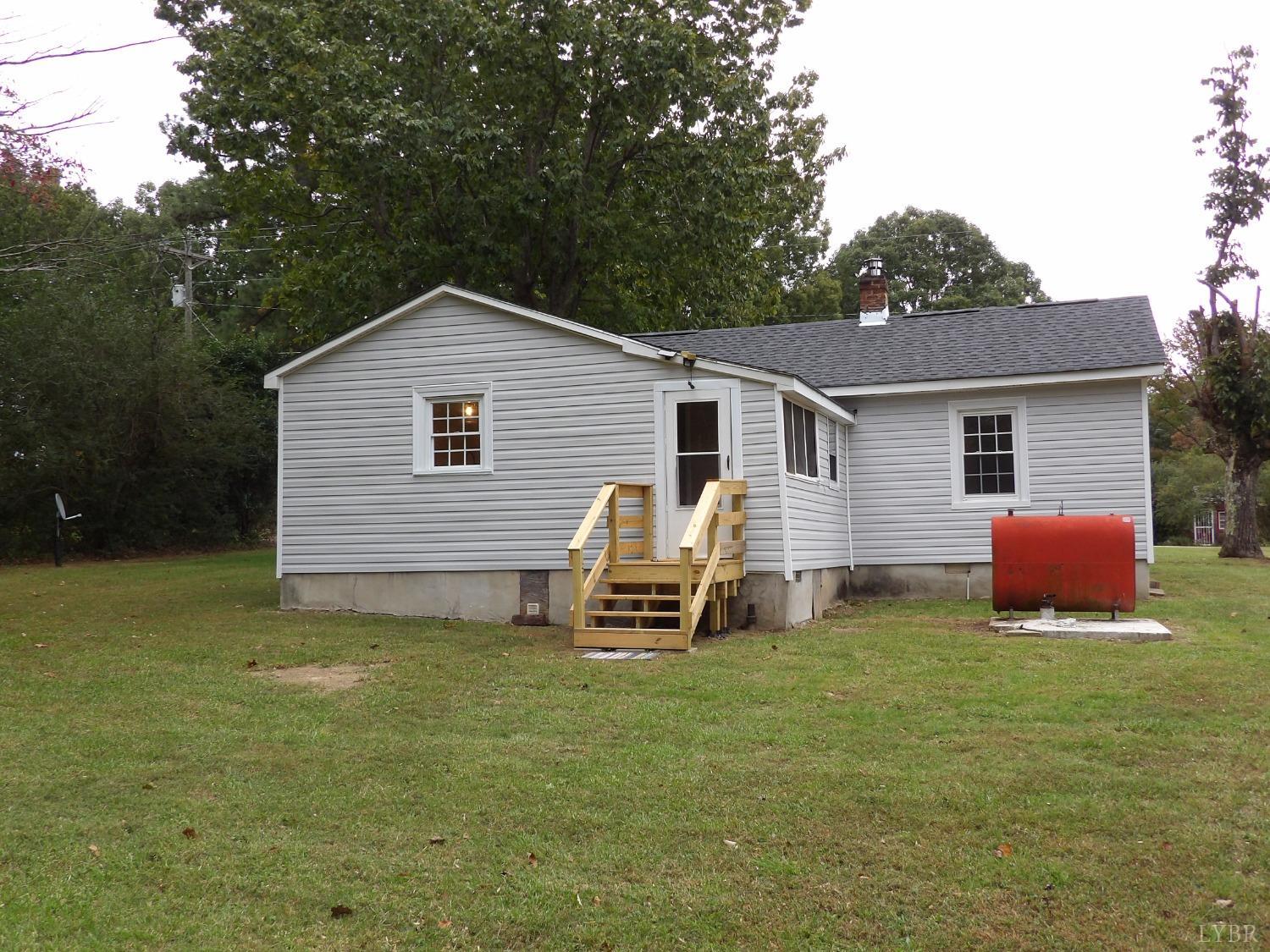 7143 Abilene Road Farmville, VA 23901 - Photo 29 of 38 a front view of a house with a garden and yard