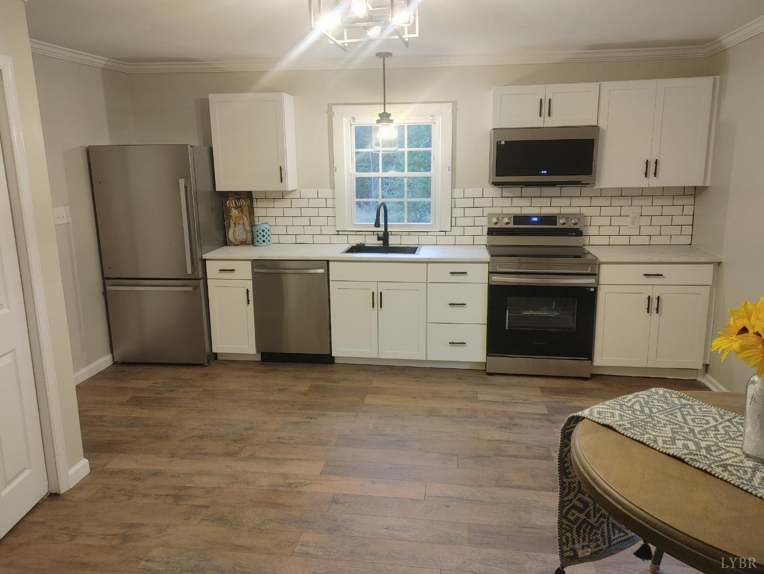 7143 Abilene Road Farmville, VA 23901 - Photo 10 of 38 a kitchen with a stove a sink and a refrigerator