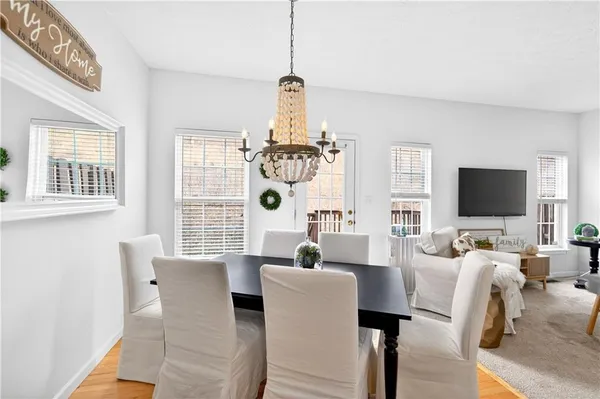 a living room with furniture a flat screen tv and a window
