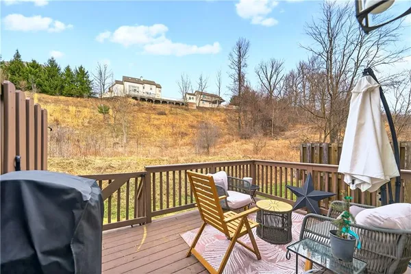 a view of a chair and table on the deck