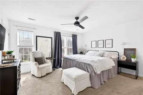 a bedroom with a bed and a couch