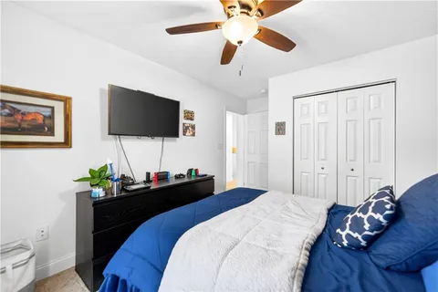 a bedroom with a bed and a flat screen tv