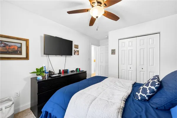 a bedroom with a bed and a flat screen tv