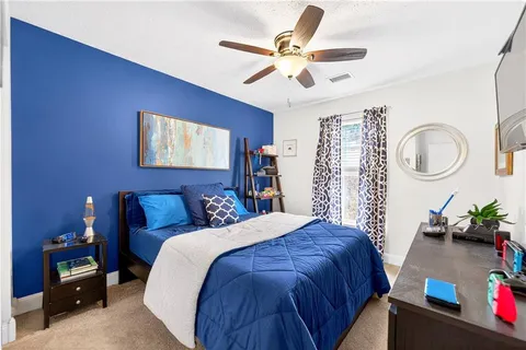 a bed room with a bed and a chandelier