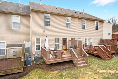 a view of a house with pool deck and furniture