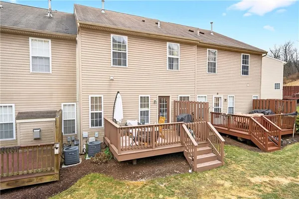 a view of a house with pool deck and furniture