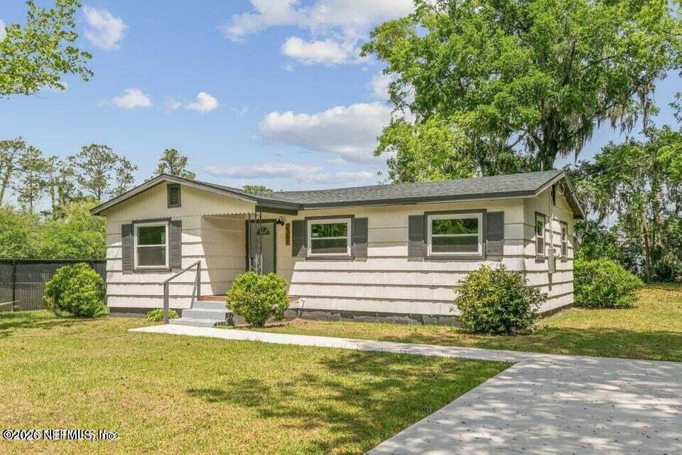 a front view of a house with a yard