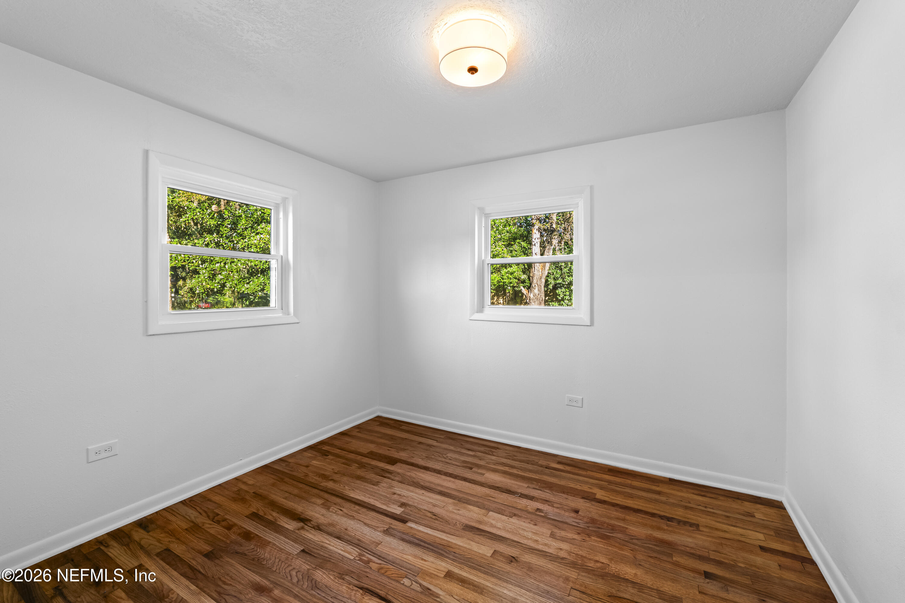 2389 Hilly Road Jacksonville, FL 32208 - Photo 11 of 25 a view of empty room with window and wooden floor