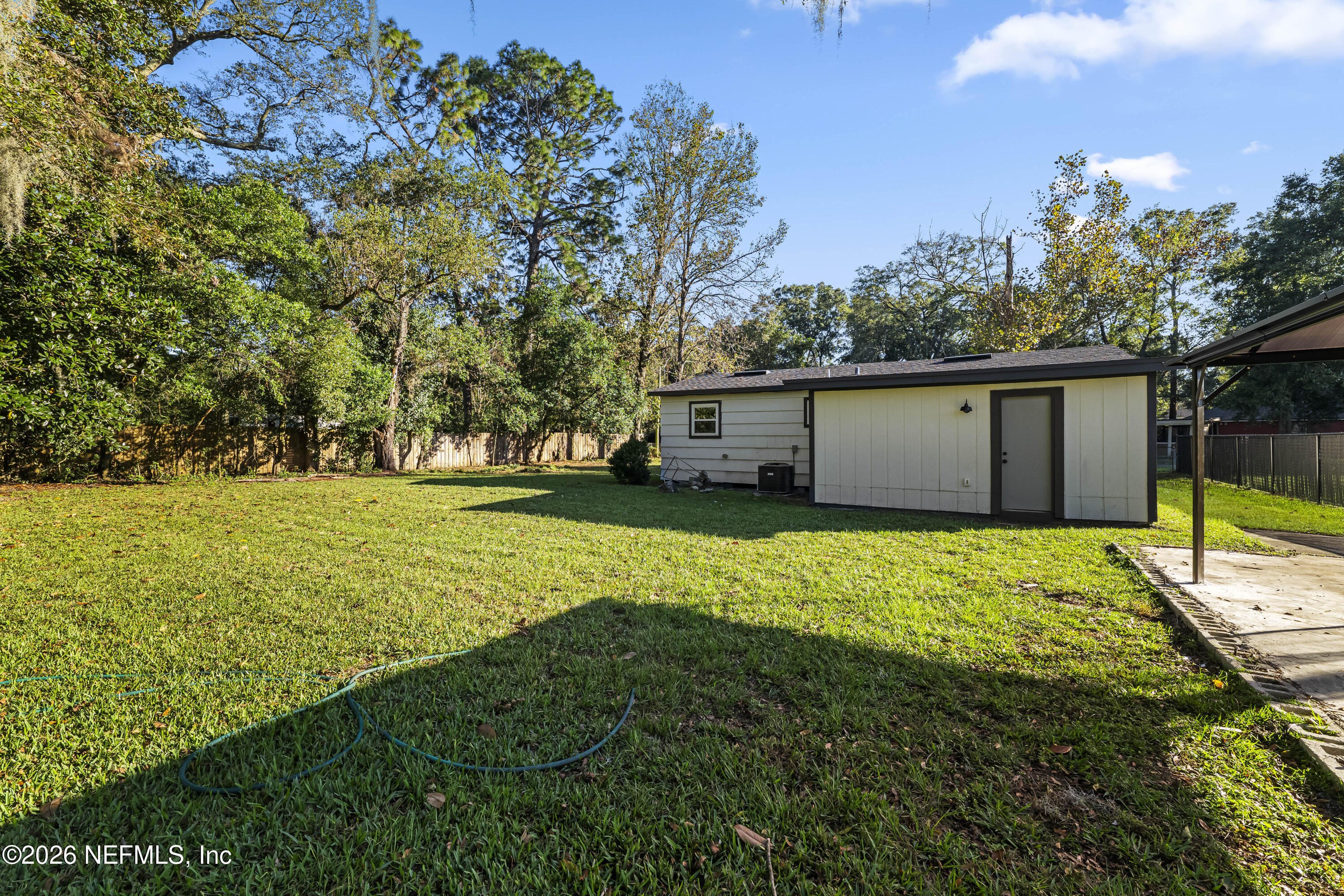 2389 Hilly Road Jacksonville, FL 32208 - Photo 17 of 25 a view of a house with backyard and trees