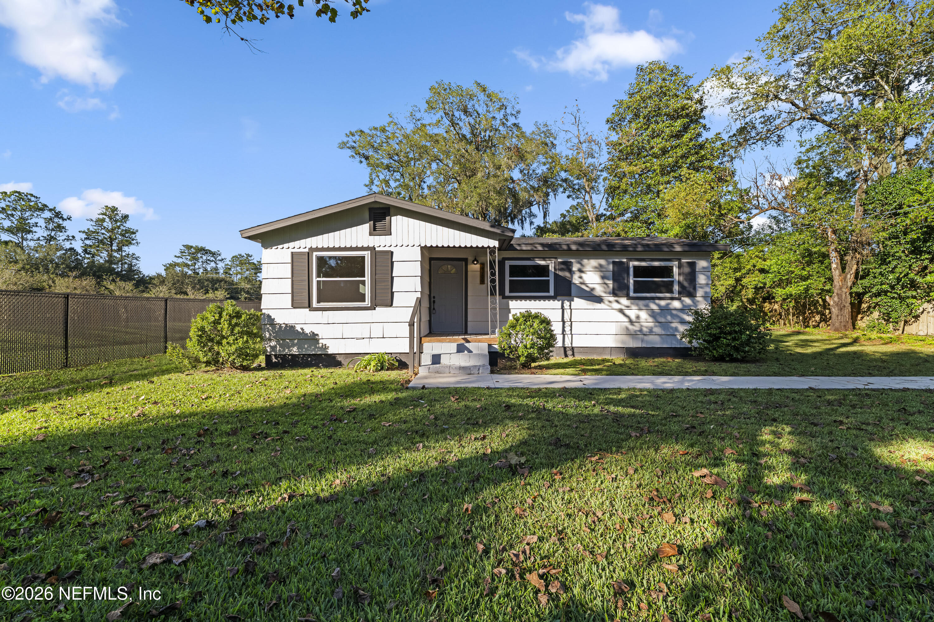 2389 Hilly Road Jacksonville, FL 32208 - Photo 19 of 25 a front view of a house with garden