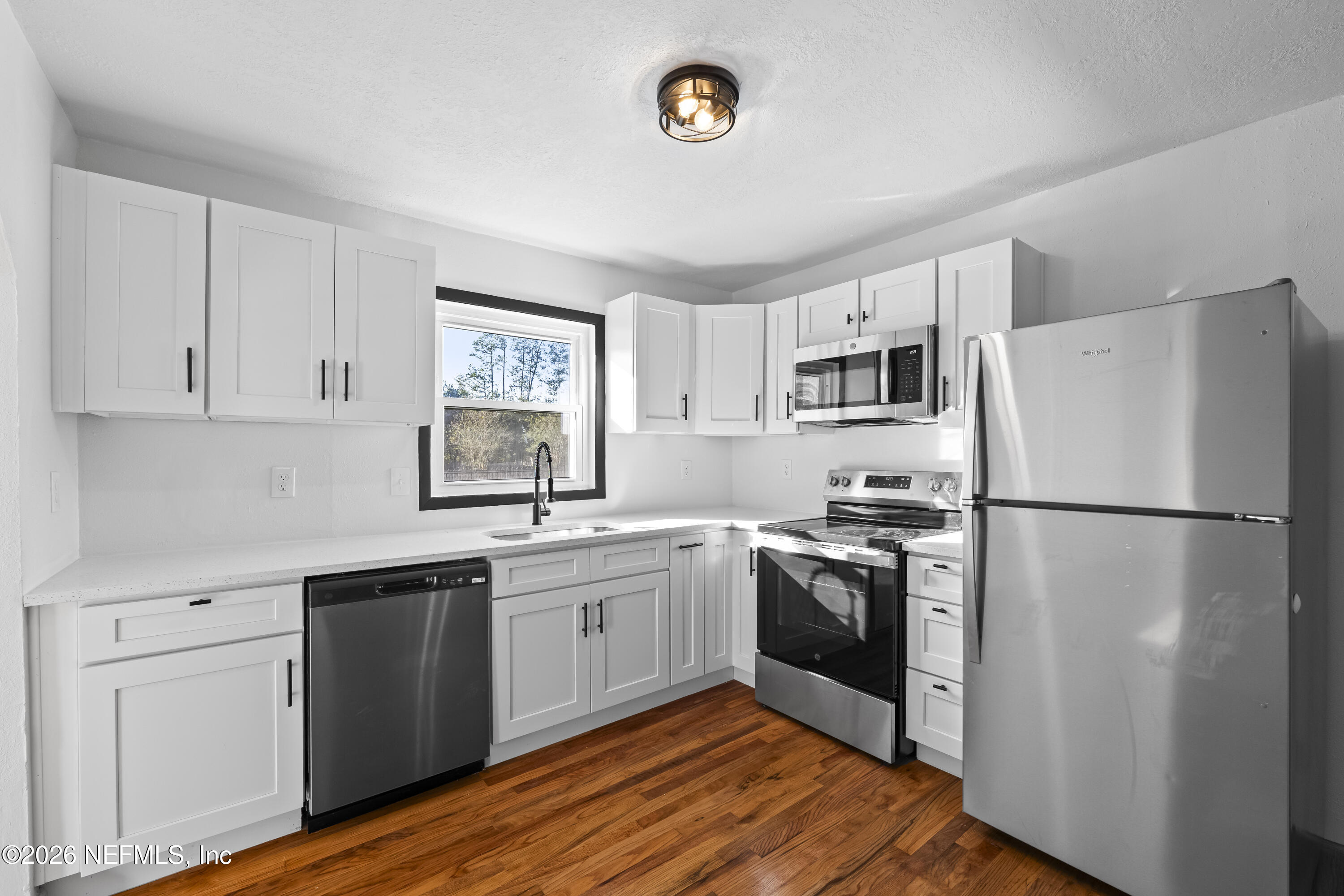 2389 Hilly Road Jacksonville, FL 32208 - Photo 4 of 25 a kitchen with a refrigerator sink and stove top oven