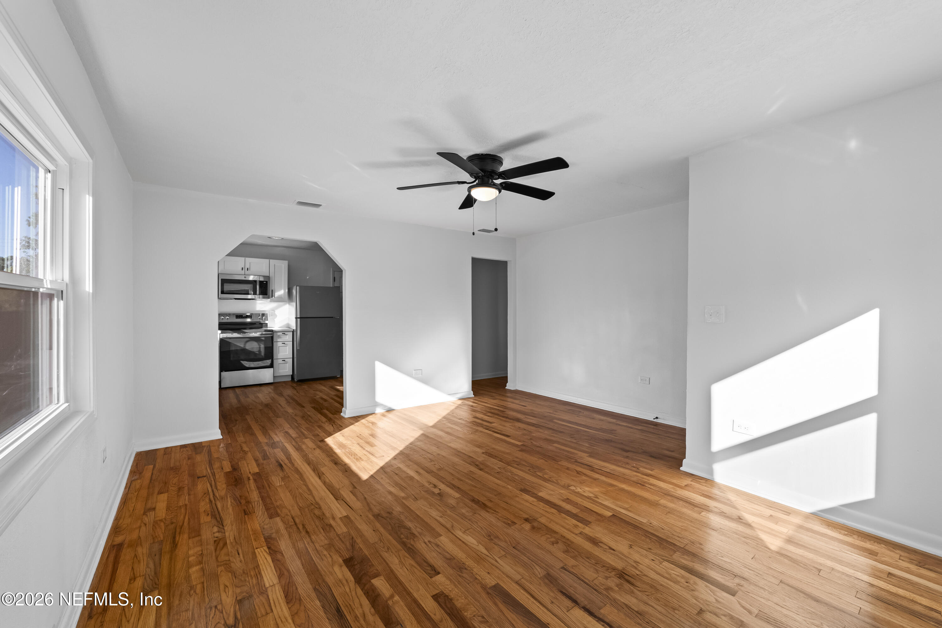 2389 Hilly Road Jacksonville, FL 32208 - Photo 7 of 25 a view of livingroom with kitchen and wooden floor