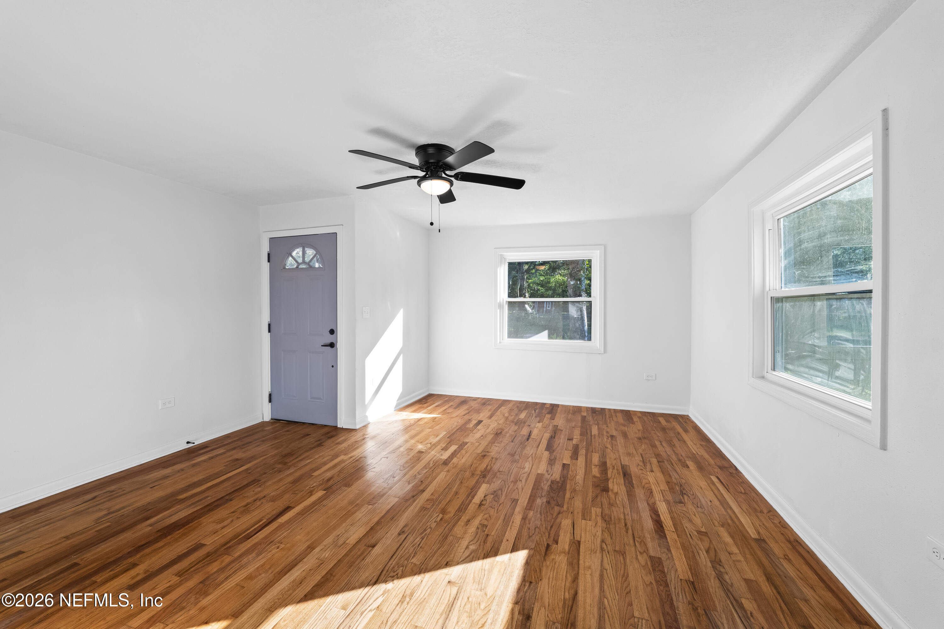 2389 Hilly Road Jacksonville, FL 32208 - Photo 9 of 25 wooden floor in an empty room with a window