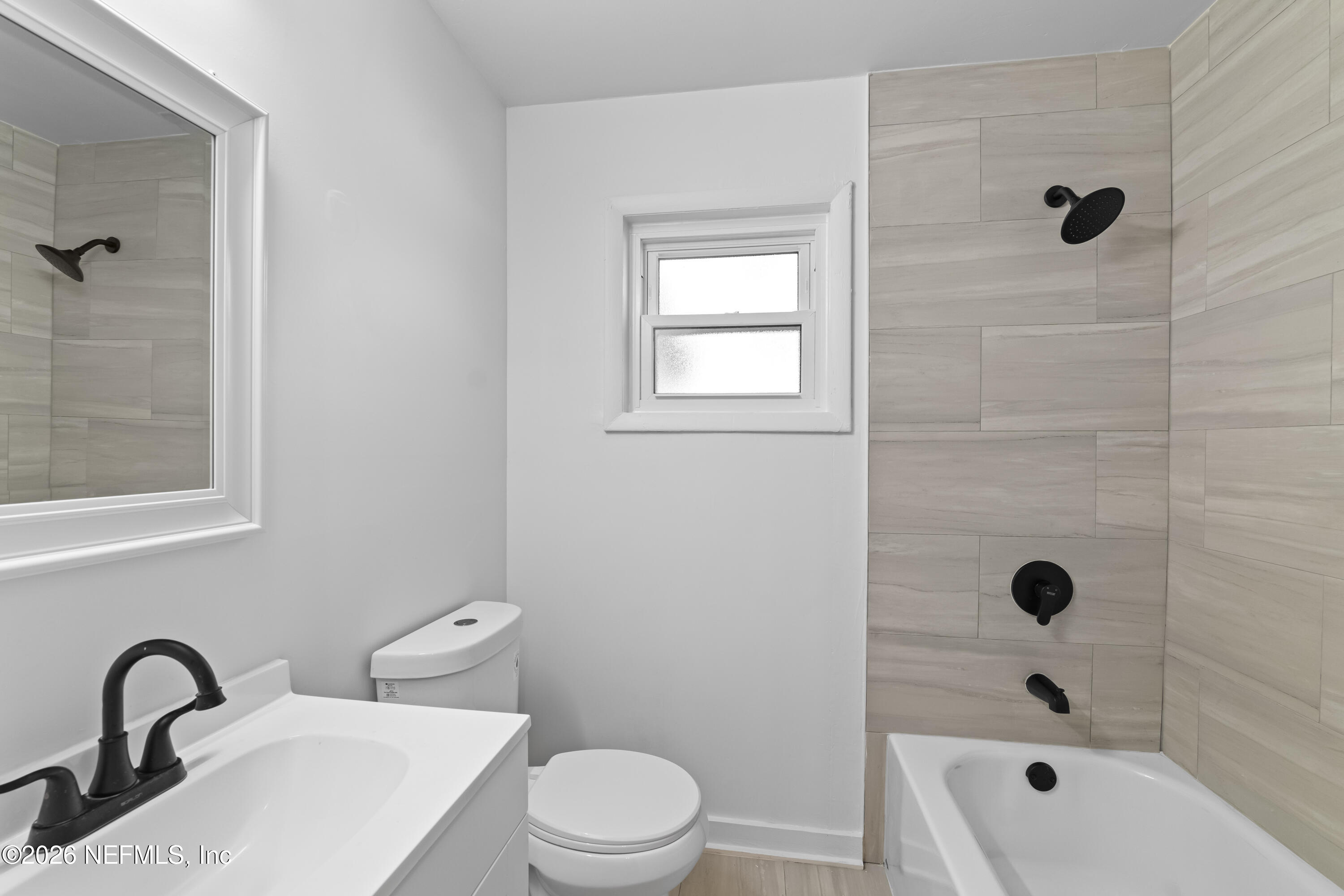 2389 Hilly Road Jacksonville, FL 32208 - Photo 10 of 25 a bathroom with a sink toilet and shower
