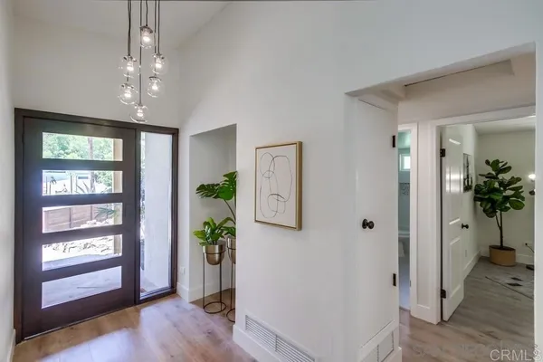 a view of an entryway of house and wooden floor