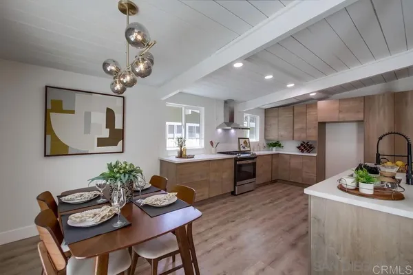 a large kitchen with a table and chairs in it