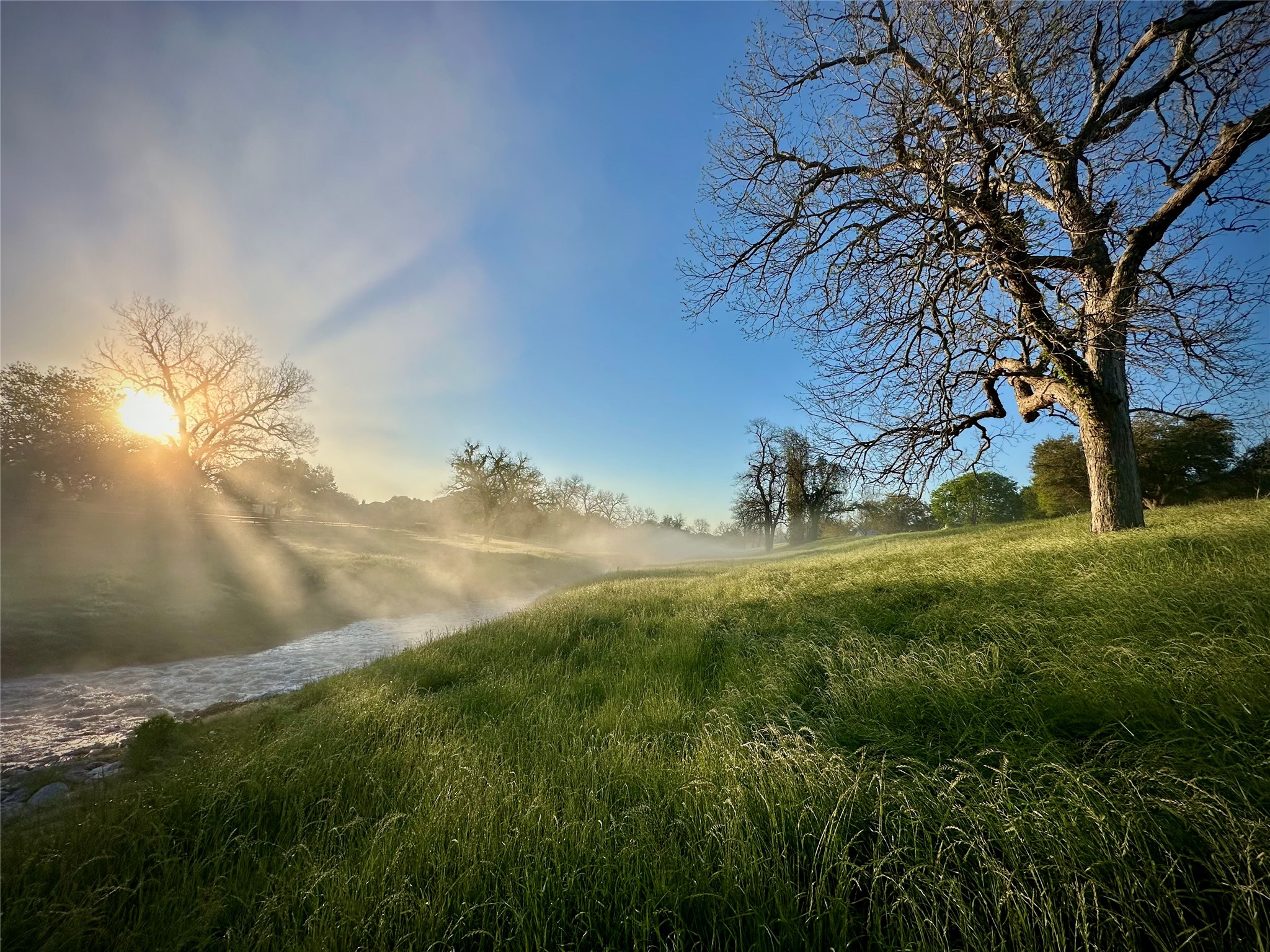 31119 Riverlake Road Fulshear, TX 77441 - Photo 23 of 27 Sun rising over Bessie's Creek, which winds its way through Fulbrook.