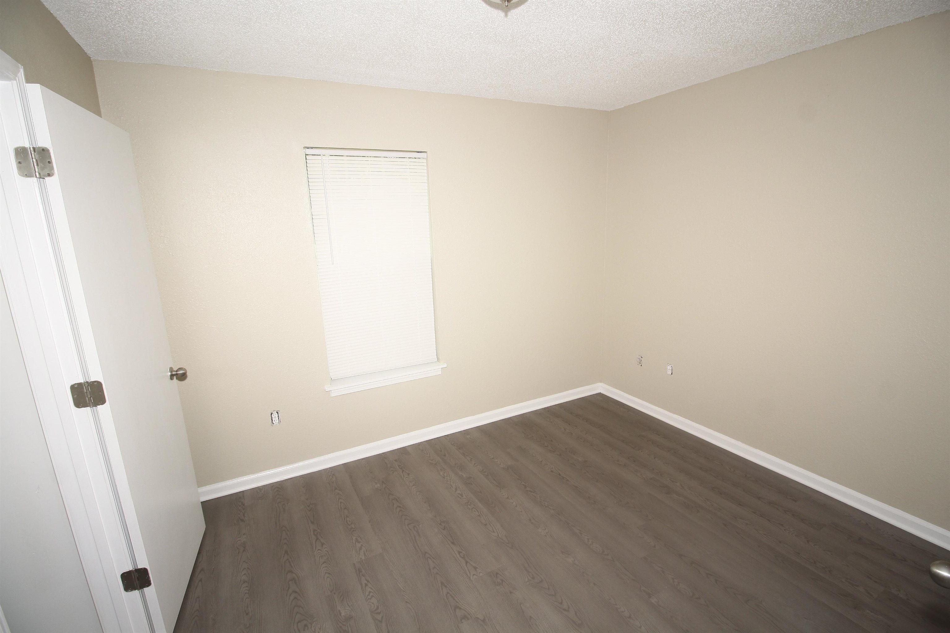 4780 Hillbrook Road Memphis, TN 38109 - Photo 11 of 14 an empty room with a wooden door