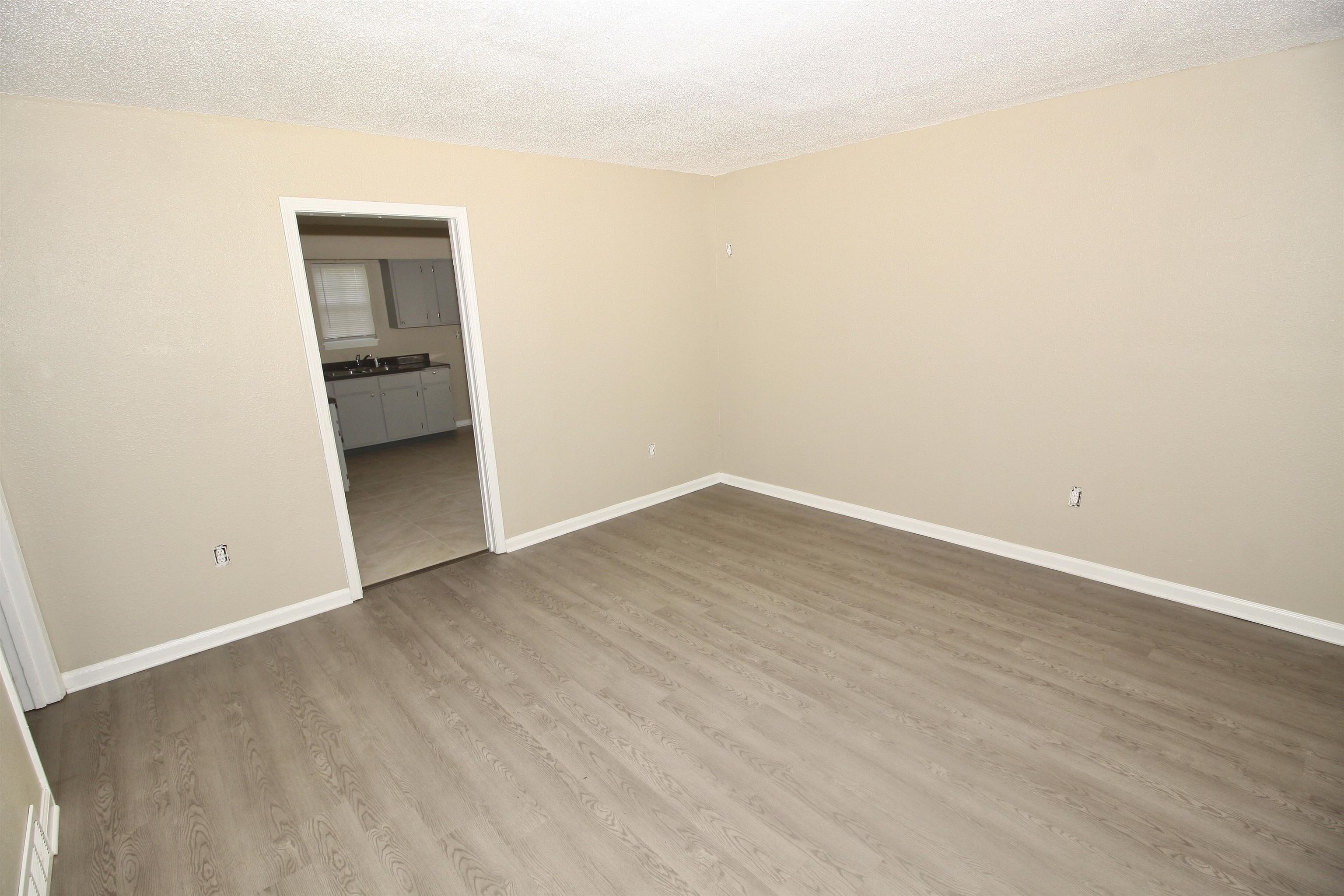 4780 Hillbrook Road Memphis, TN 38109 - Photo 12 of 14 an empty room with wooden floor and bathroom