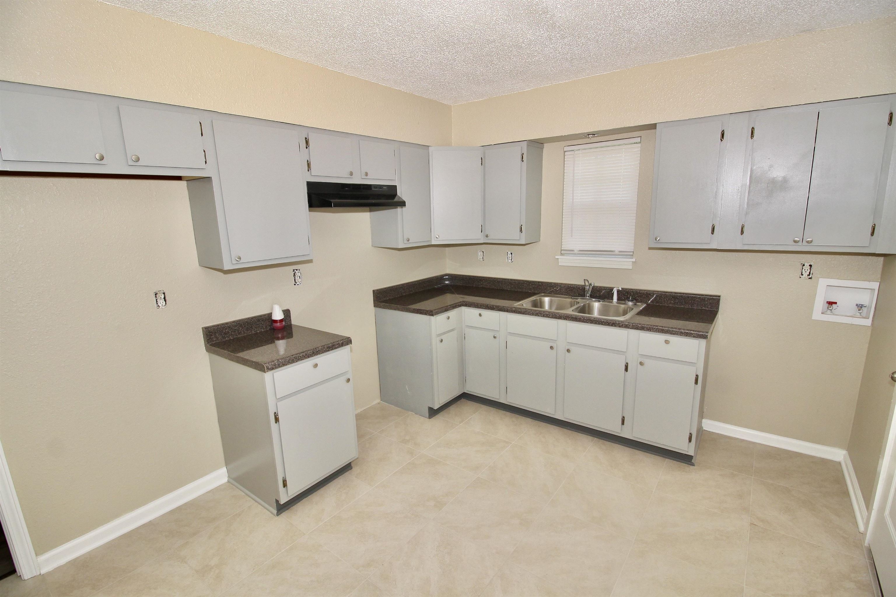 4780 Hillbrook Road Memphis, TN 38109 - Photo 3 of 14 a kitchen with white cabinets and white appliances