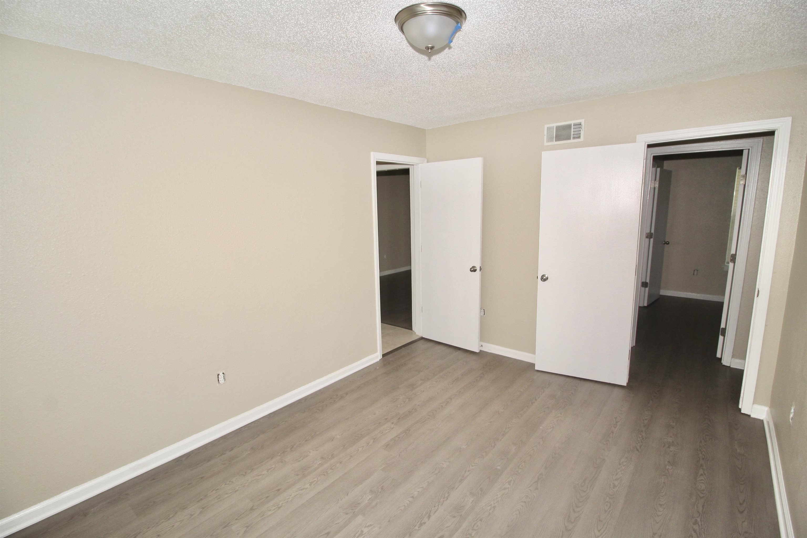 4780 Hillbrook Road Memphis, TN 38109 - Photo 7 of 14 an empty room with wooden floor