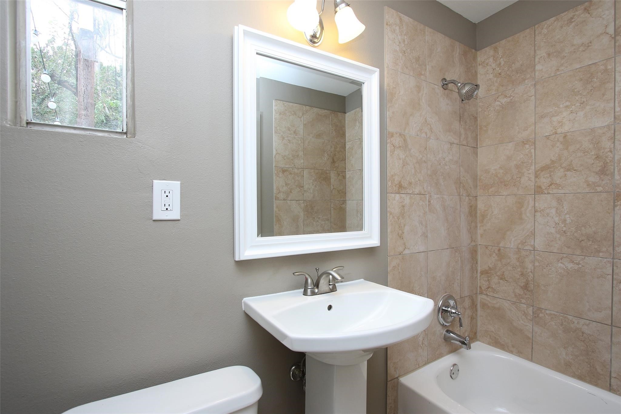 1127 Walling Street Houston, TX 77009 - Photo 14 of 23 a bathroom with a sink a toilet and shower
