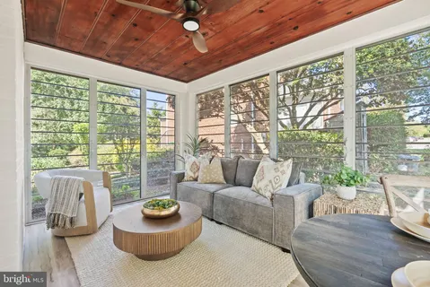 a living room with furniture and a floor to ceiling window