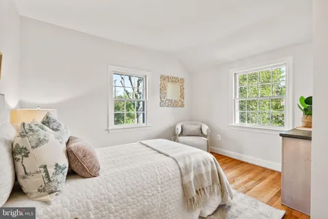 a bedroom with a bed and painting on the wall