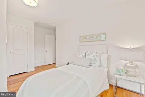 a bathroom with a sink a toilet a mirror a bathtub and shower