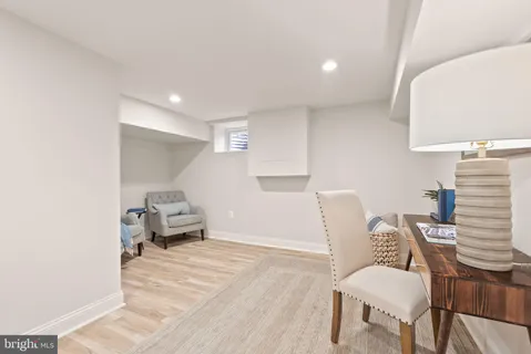 a view of a kitchen with furniture and wooden floor