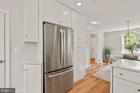 a kitchen with granite countertop a sink stove and cabinets