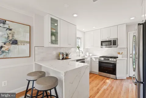 a kitchen with a stove a sink and a refrigerator