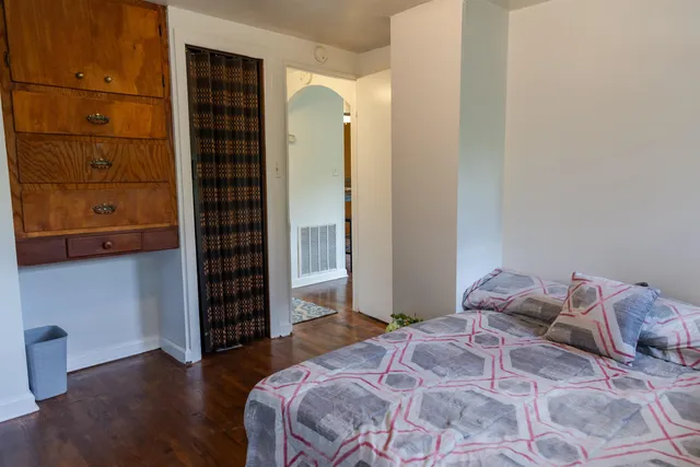 a bedroom with a bed and windows