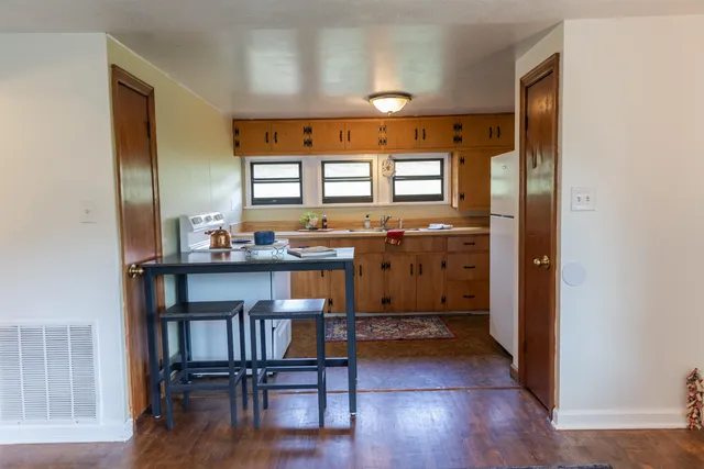 a view of a dining room with furniture and a window