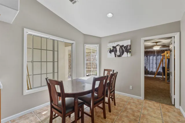 a view of a dining room with furniture and window