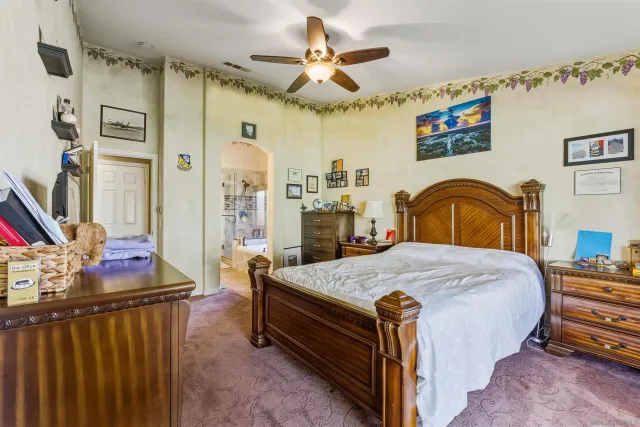 a bedroom with bed and a chandelier