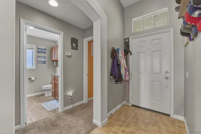 a view of a hallway with bathroom and shower
