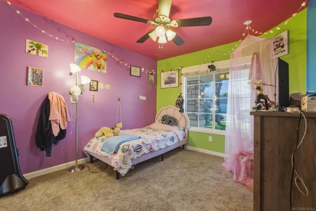 a bedroom with a bed dresser and a window