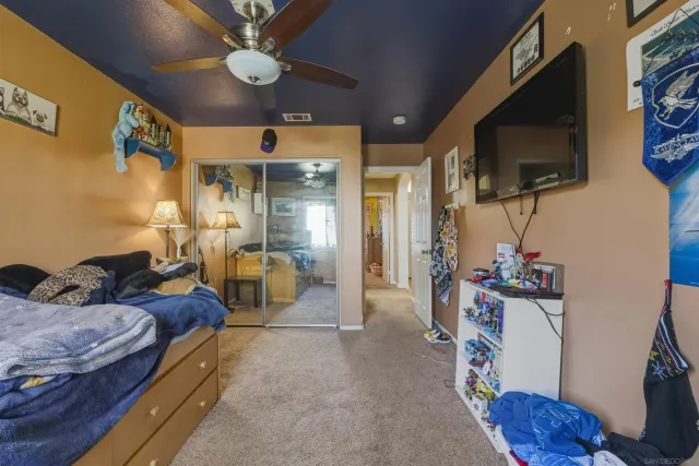 a bedroom with furniture and a flat screen tv