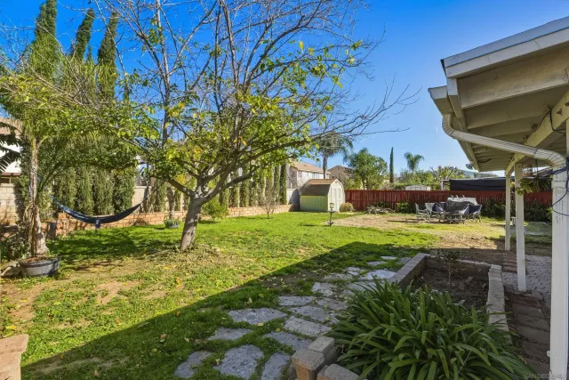a view of backyard with swimming pool