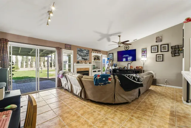 a living room with furniture large window and flat screen tv